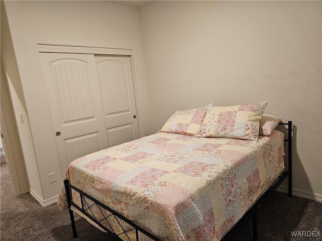 bedroom featuring a closet, dark carpet, and baseboards