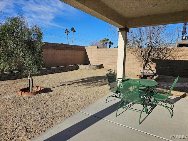 view of patio with outdoor dining space and a fenced backyard