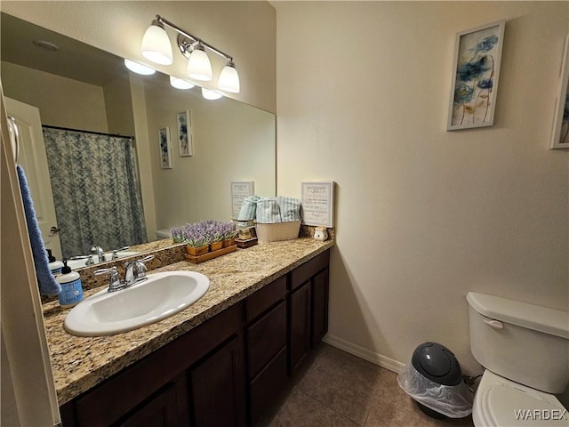 full bath with toilet, tile patterned flooring, vanity, and baseboards