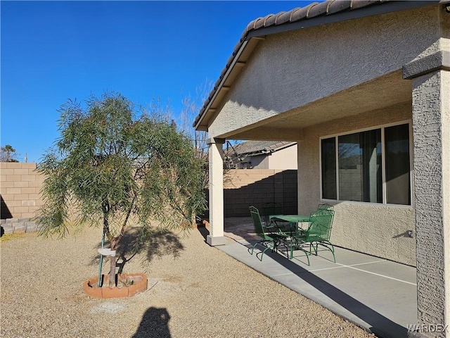 view of yard featuring fence and a patio