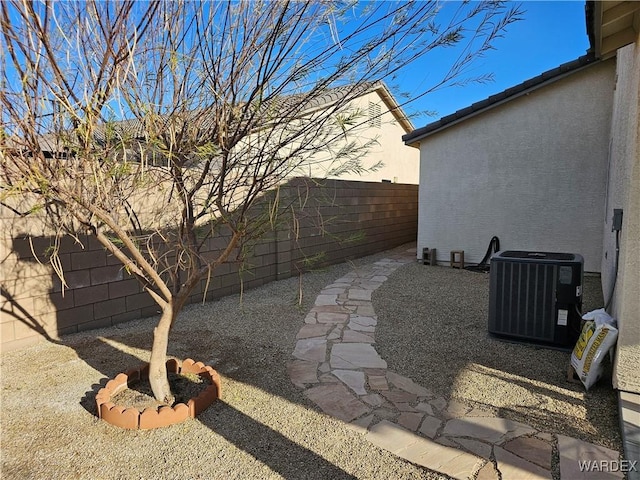 view of yard featuring a fenced backyard and central AC