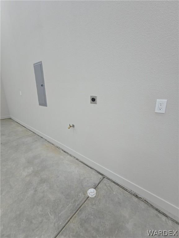 interior space featuring baseboards, laundry area, electric panel, and hookup for an electric dryer