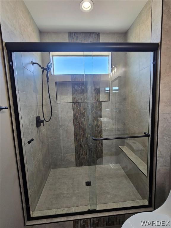 bathroom with a shower stall