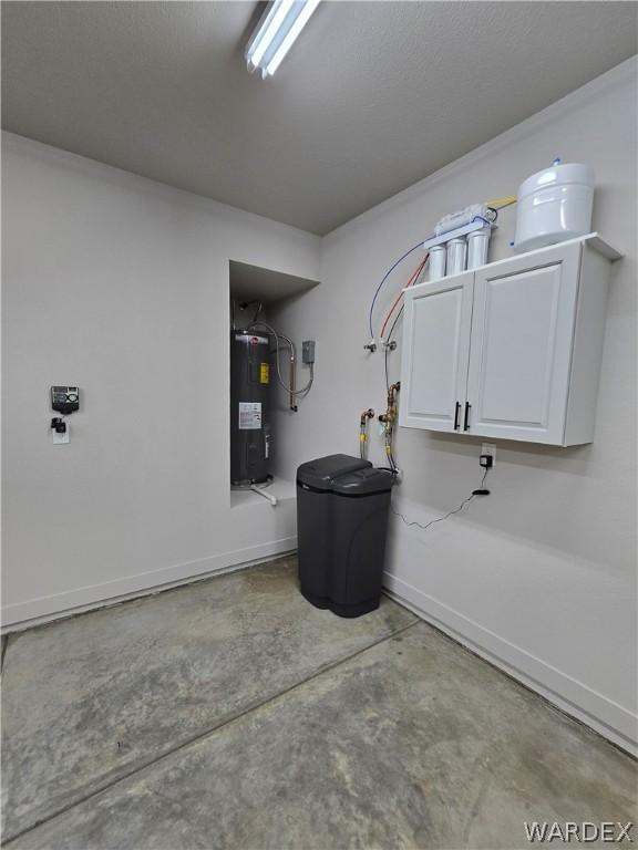 garage with electric water heater and baseboards