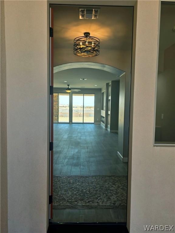 hallway with arched walkways and visible vents