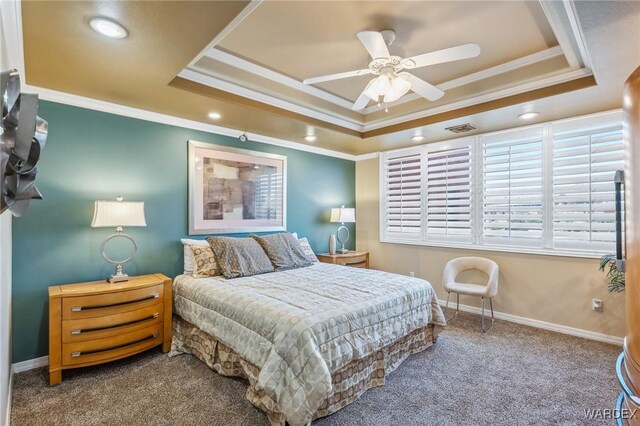 carpeted bedroom featuring ornamental molding, a tray ceiling, visible vents, and baseboards