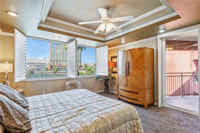 carpeted bedroom featuring baseboards, access to outside, a raised ceiling, and crown molding