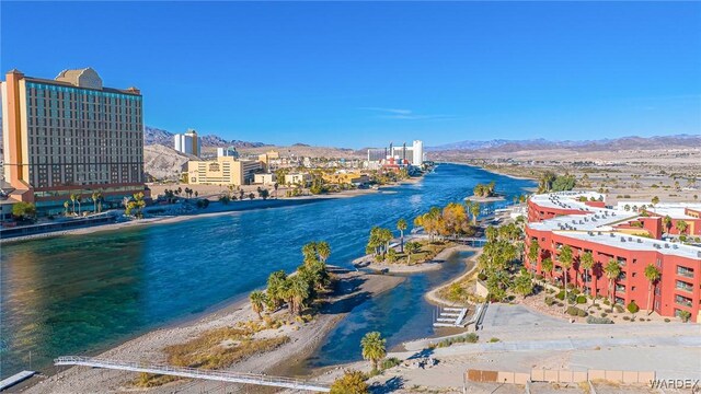 property view of water with a view of the beach, a view of city, and a mountain view