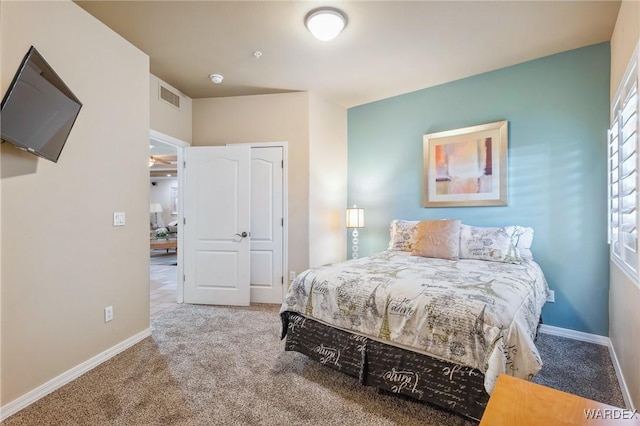 carpeted bedroom with visible vents and baseboards