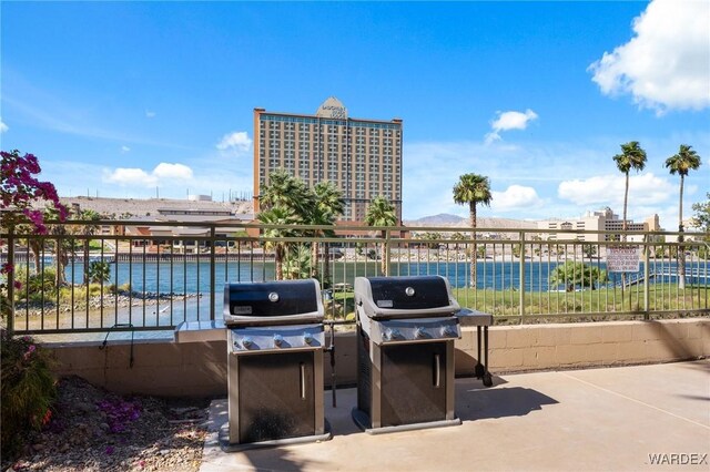 view of patio / terrace with a water view and a grill