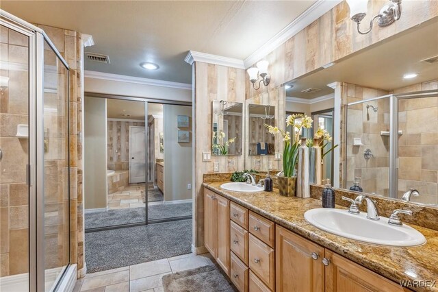 full bathroom with a shower stall, a sink, visible vents, and crown molding