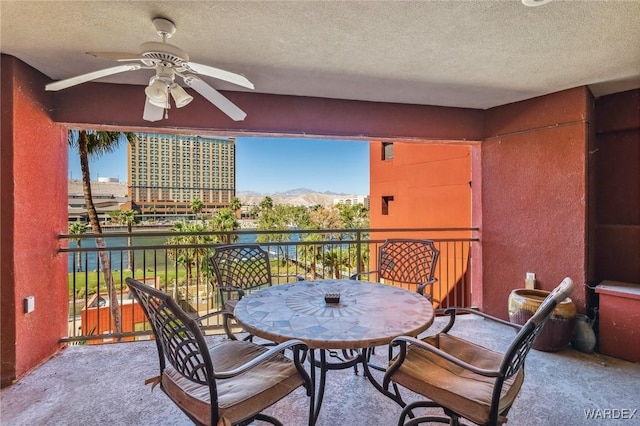 balcony featuring ceiling fan and a mountain view