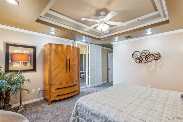 bedroom with carpet floors, baseboards, visible vents, and a raised ceiling