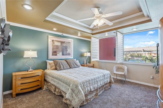 carpeted bedroom featuring ceiling fan, recessed lighting, baseboards, a raised ceiling, and crown molding