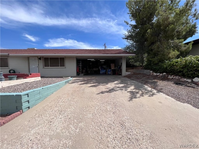 ranch-style house with entry steps, driveway, and an attached garage