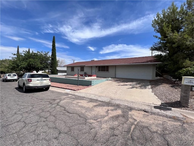 single story home featuring a garage and driveway