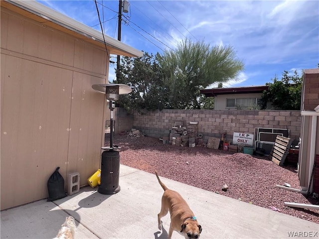 view of patio featuring fence