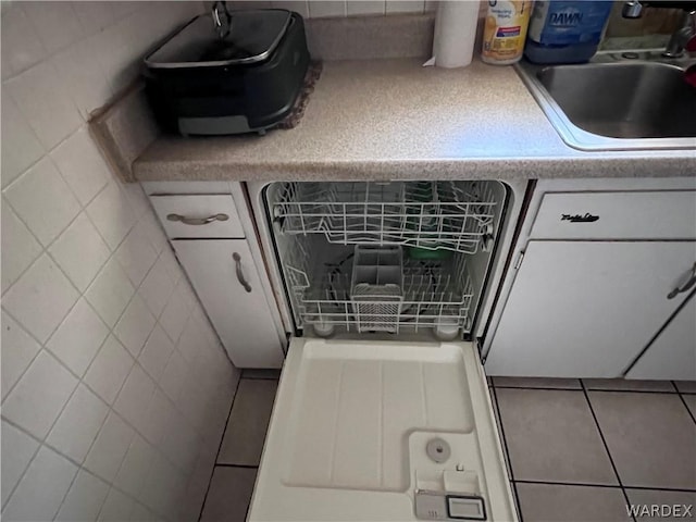 details with light countertops, a sink, and dishwasher