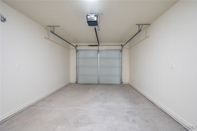 garage featuring a garage door opener and baseboards