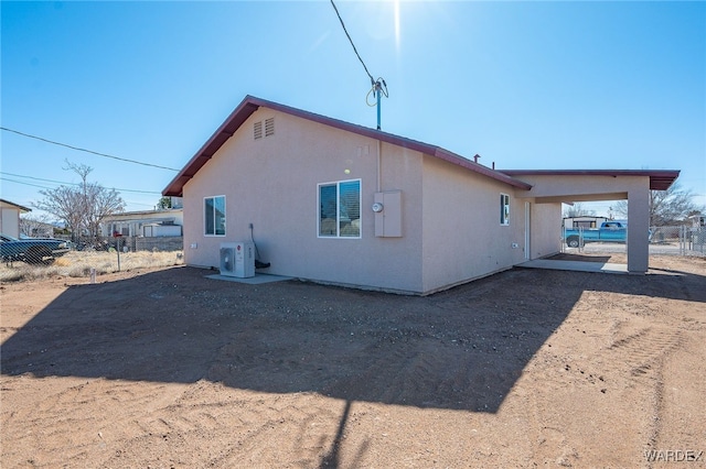 view of property exterior featuring ac unit, fence, and stucco siding