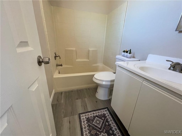 full bathroom with shower / bathing tub combination, vanity, toilet, and wood finished floors