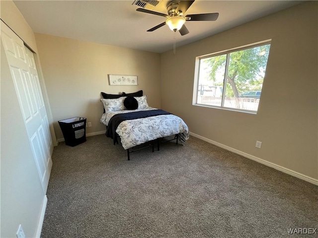 carpeted bedroom with ceiling fan, a closet, and baseboards