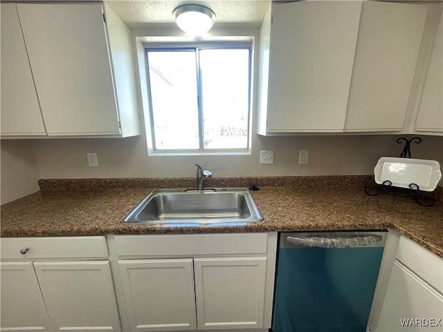 kitchen with a sink, white cabinetry, and dishwasher