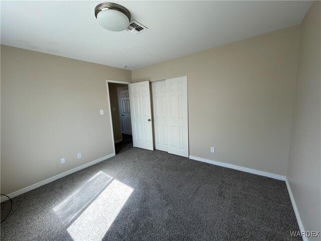 unfurnished bedroom featuring a closet, visible vents, and baseboards