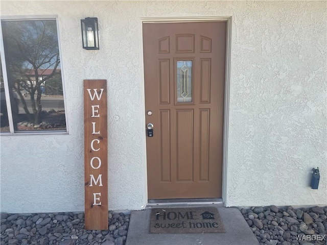 entrance to property with stucco siding