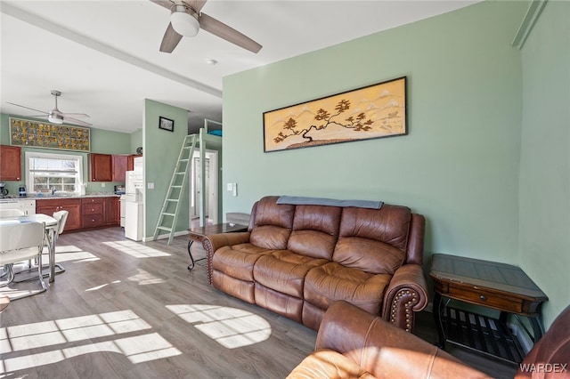 living area with ceiling fan and wood finished floors