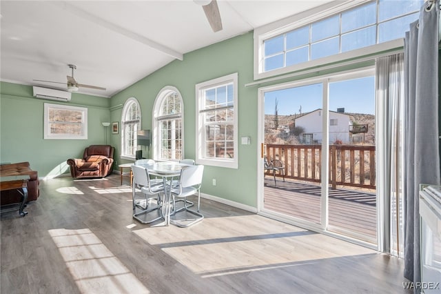 dining area with wood finished floors, a ceiling fan, baseboards, a wall mounted AC, and vaulted ceiling with beams