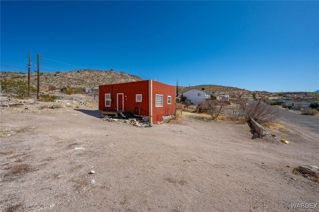 view of outbuilding with a mountain view and entry steps