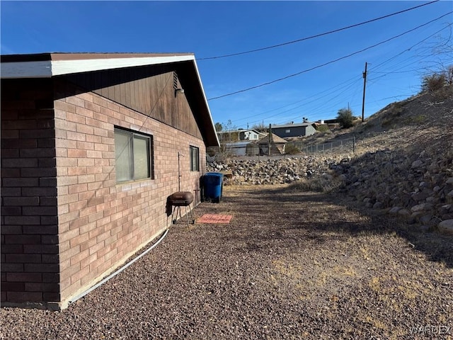 view of property exterior with brick siding