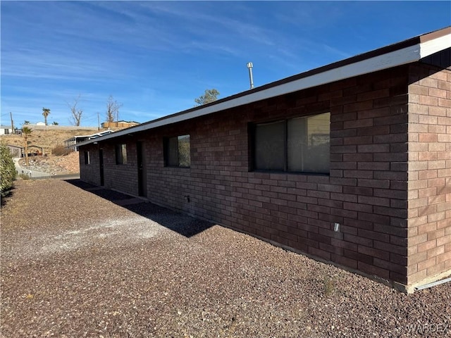 view of side of property featuring brick siding