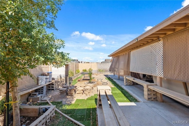 view of yard featuring a garden and a fenced backyard