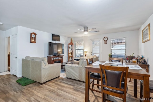 living room with wood finished floors and a ceiling fan