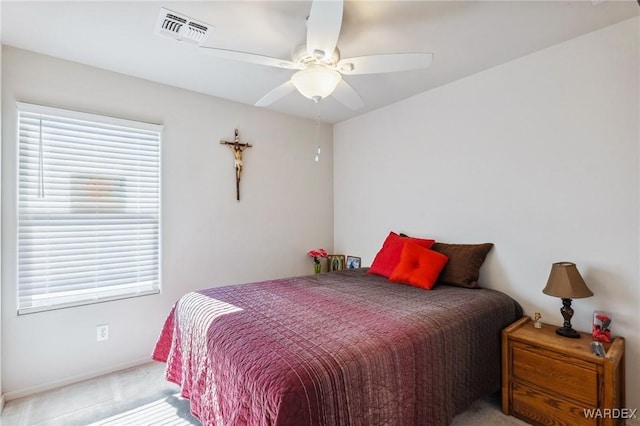 bedroom with a ceiling fan, light colored carpet, and visible vents