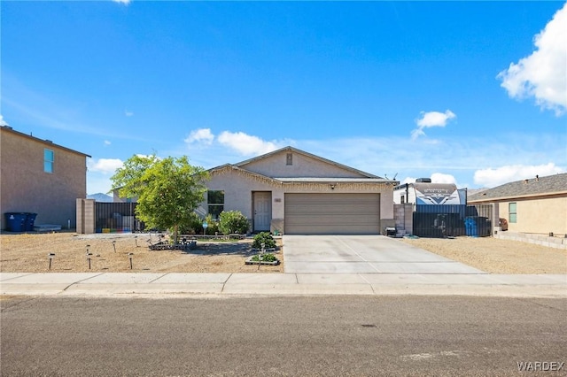 single story home featuring stucco siding, concrete driveway, a gate, fence, and a garage