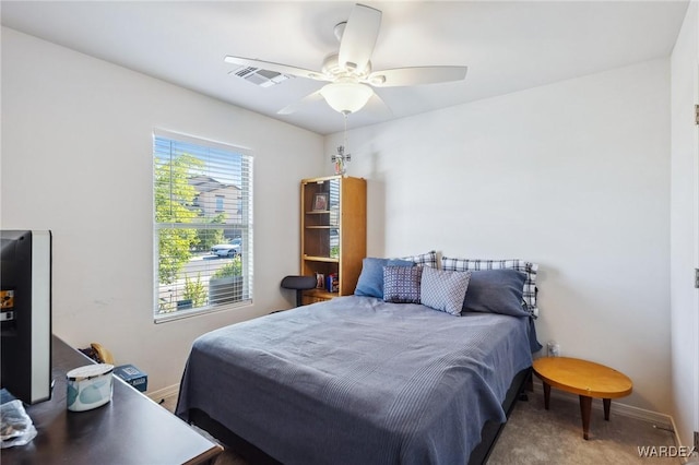 bedroom with ceiling fan, visible vents, and baseboards