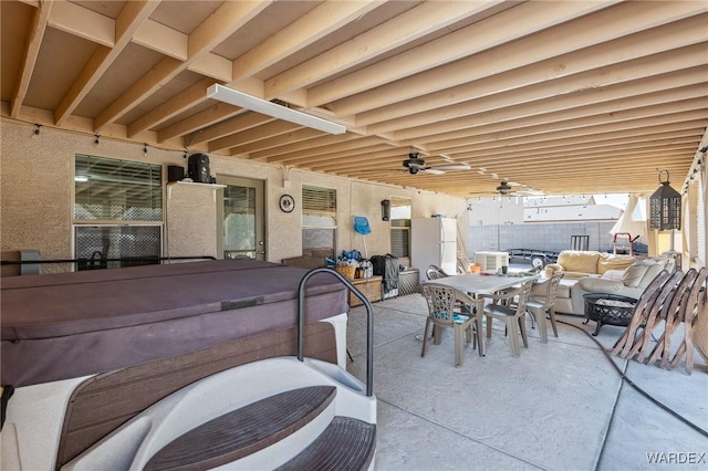 view of patio featuring an outdoor hangout area, ceiling fan, outdoor dining space, and a hot tub