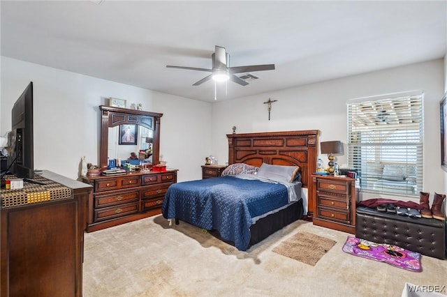 bedroom with a ceiling fan, light colored carpet, and visible vents