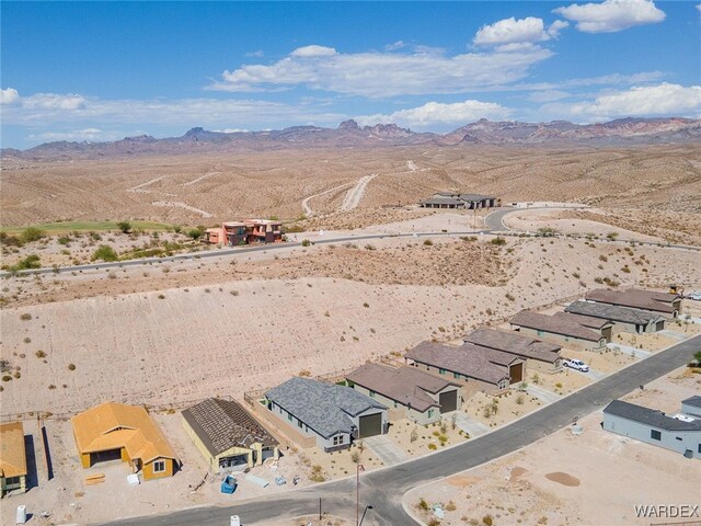 birds eye view of property featuring a residential view, view of desert, and a mountain view