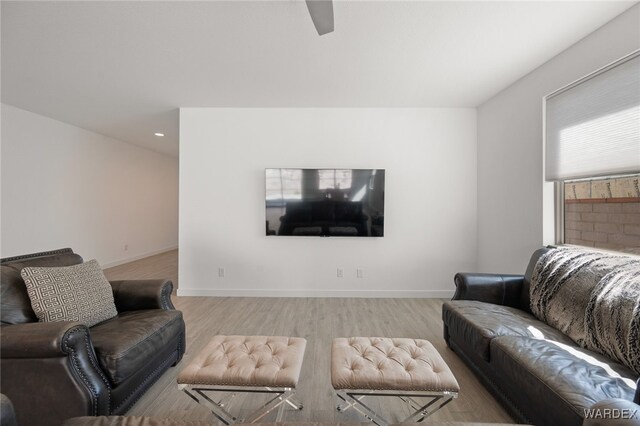 living area with light wood finished floors and baseboards