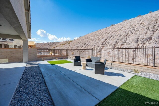 view of patio with a fenced backyard and a mountain view