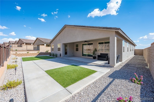 back of house with a patio, a fenced backyard, a ceiling fan, and stucco siding