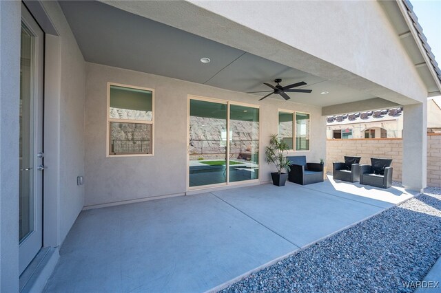 view of patio / terrace featuring fence and a ceiling fan