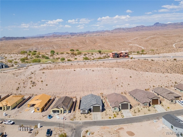 birds eye view of property featuring view of desert, a residential view, and a mountain view