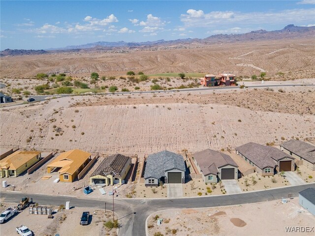 birds eye view of property with a residential view, a mountain view, and view of desert