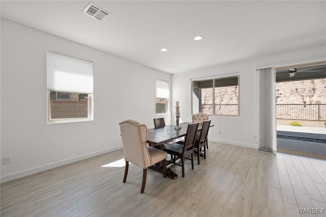 dining room with recessed lighting, baseboards, visible vents, and light wood finished floors