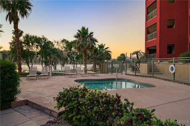 231 Moser Ave Unit G, Bullhead City, AZ 86429 - pool at dusk with a community pool, a patio area, and fence